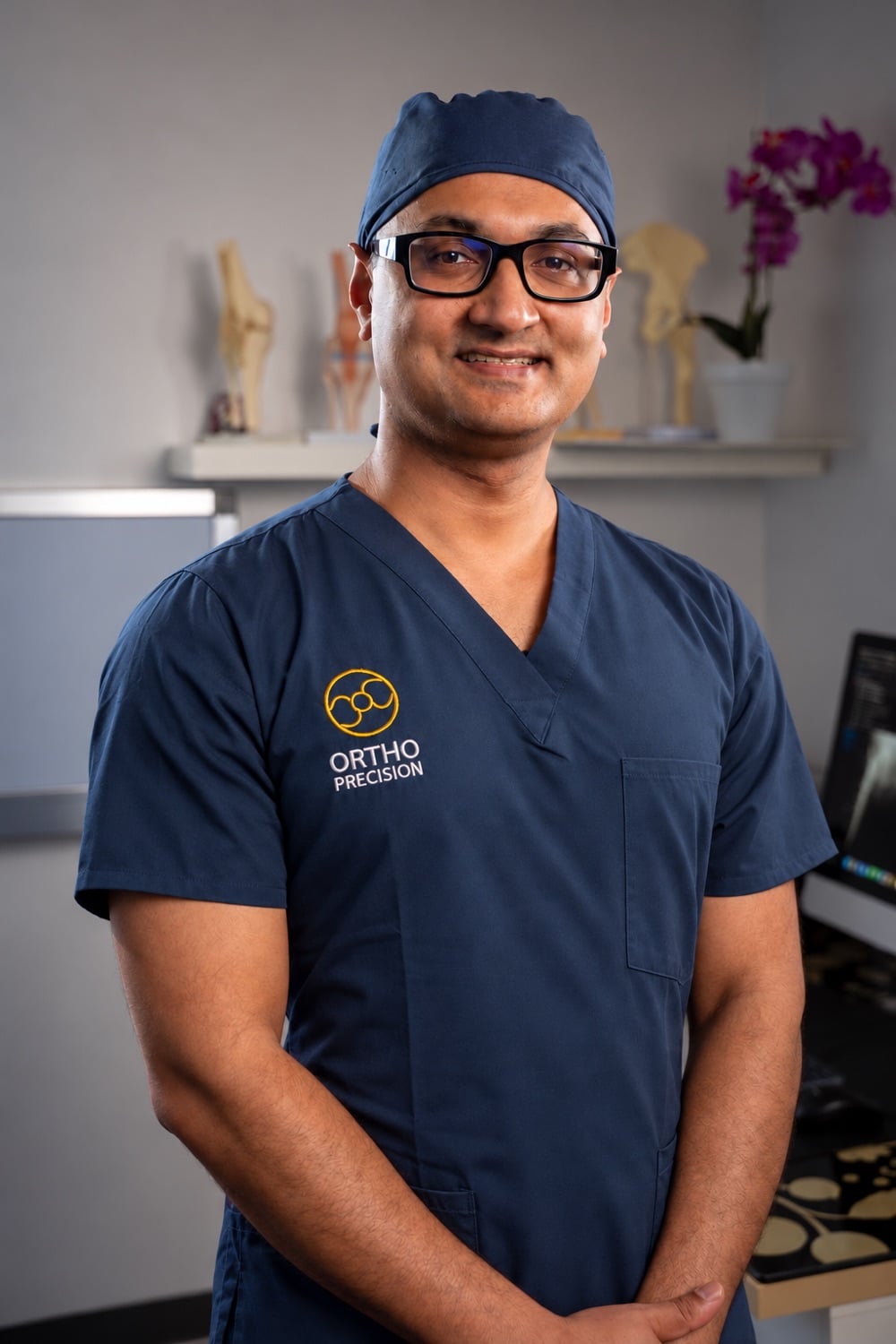 Dr Yas Edirisinghe in surgical scrubs.